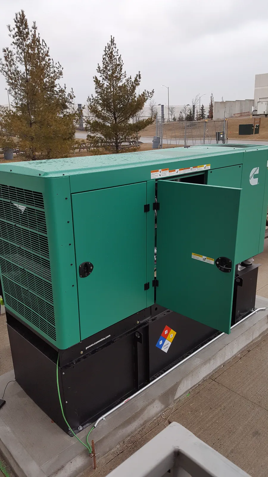 Exterior commercial generator equipment beside a building.