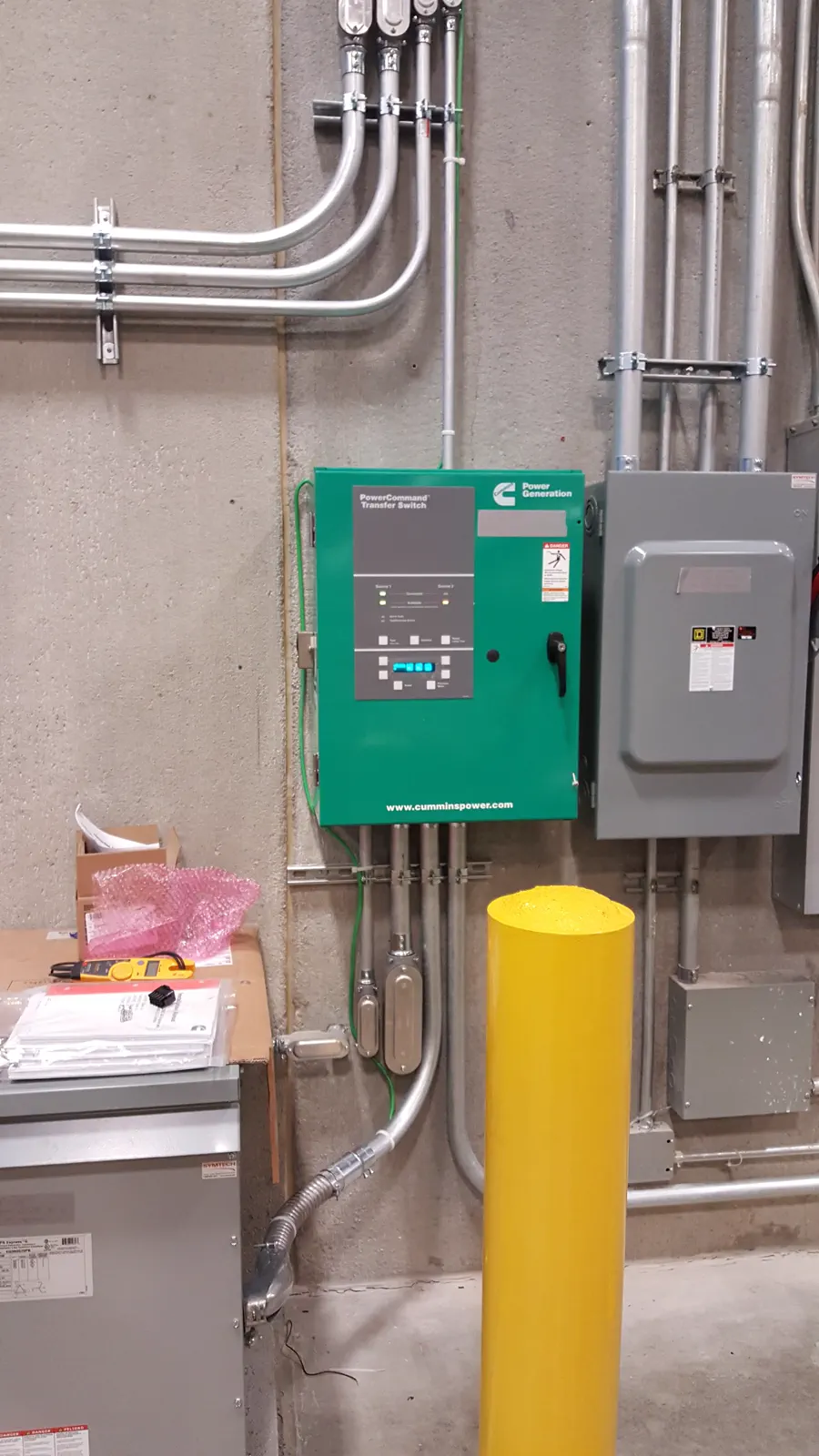 Commercial power control equipment with conduit and wiring.