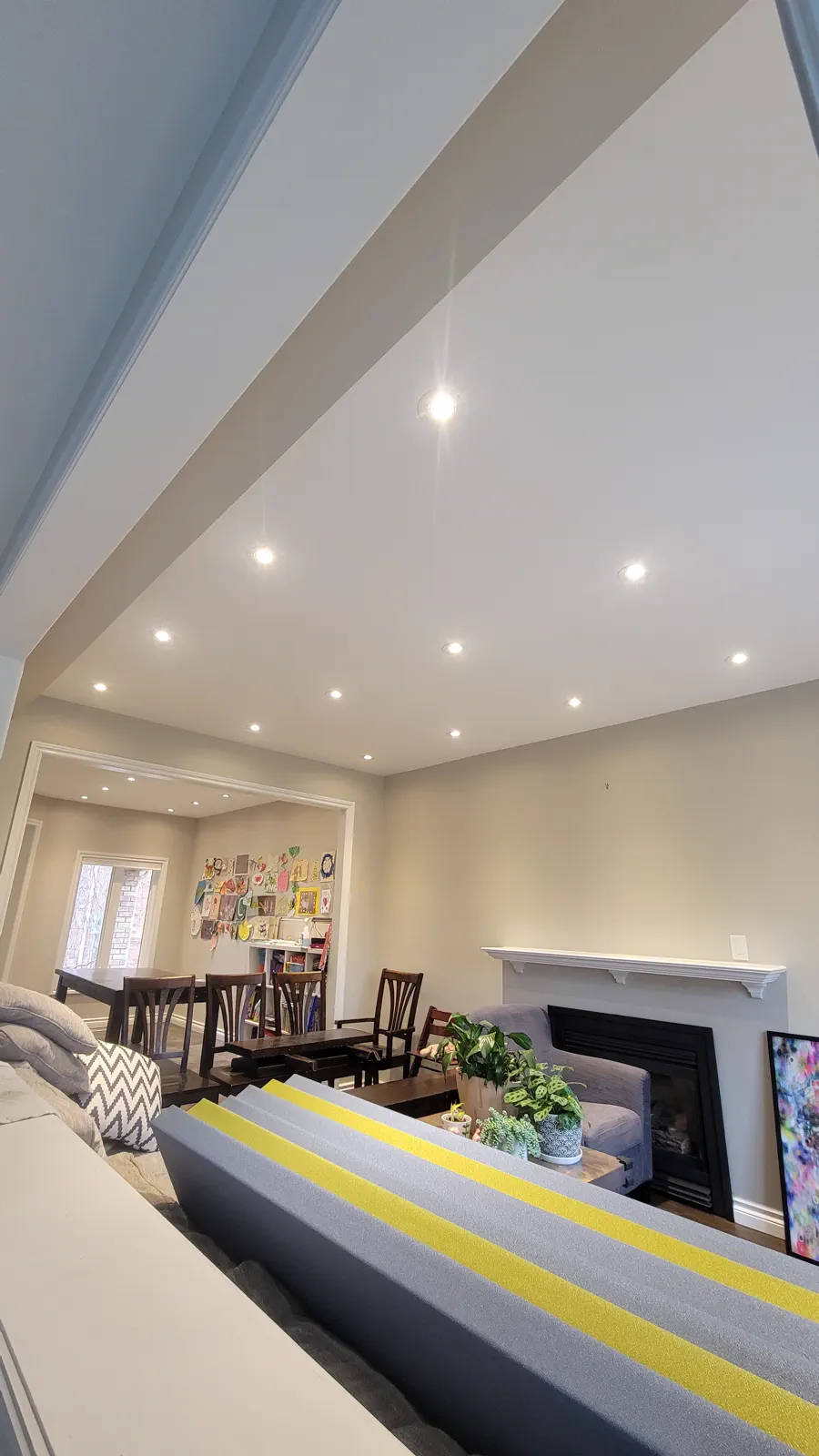 Finished residential ceiling with recessed pot lights.