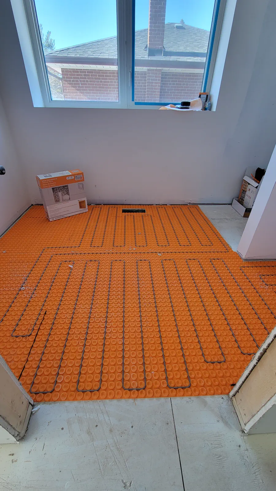 Residential electric floor warming mat and heating wire installed before finished flooring.