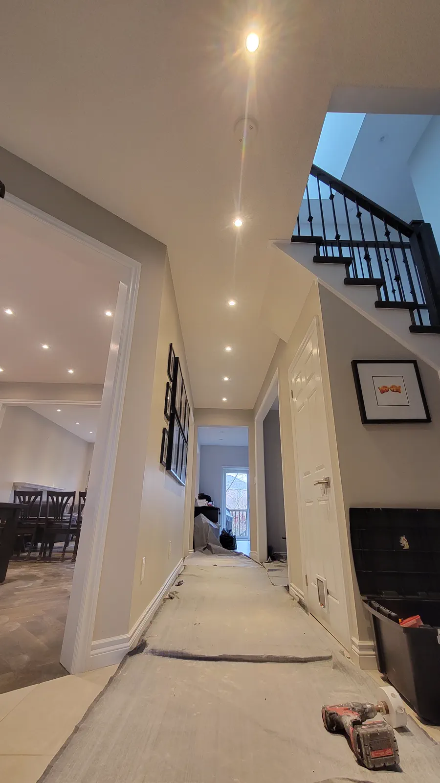 Residential hallway with recessed pot lights.